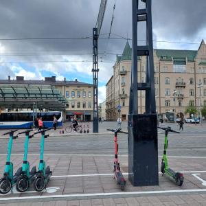 Parked electric scooters in a parking square at the Keskustori along Hämeenkatu.